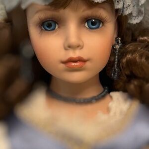 SOLD Porcelain Doll with Blue Eyes and Brown Hair